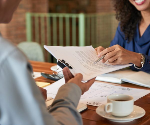 Businessman consulting with lawyer before signing contract